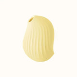 A compact, ergonomic lemon yellow clitoral suction device designed for pleasure, with a smooth surface and ipx7 waterproof, have fun in the tub or shower